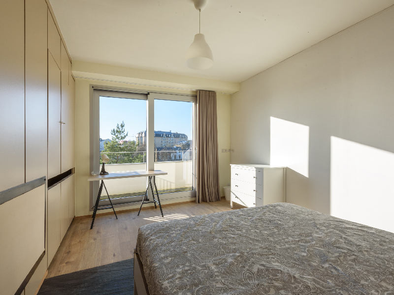 Furnished room rent Luxembourg. Includes double bed, chest of drawers, desk, balcony