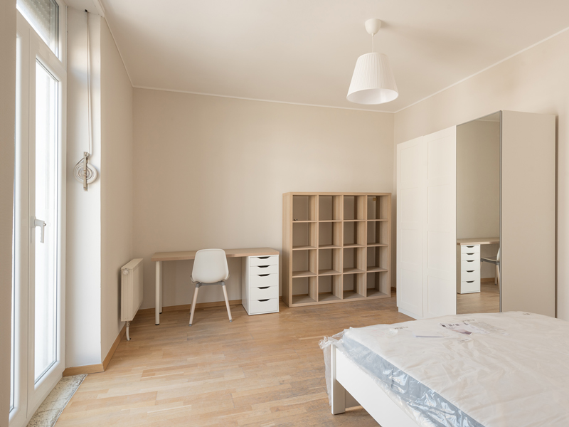 furnished room rent Luxembourg with a double bed, shelf, wardrobe, desk