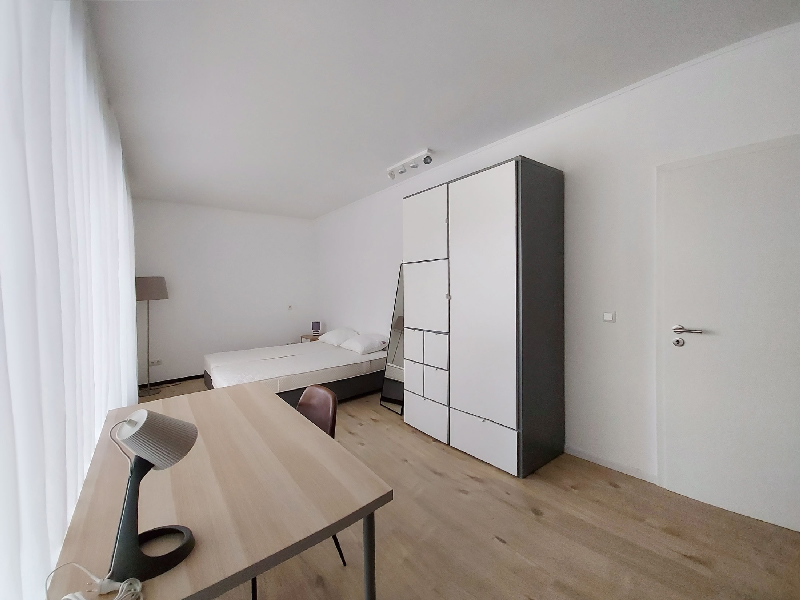 Furnished room rent Luxembourg with a double bed, wardrobe, desk