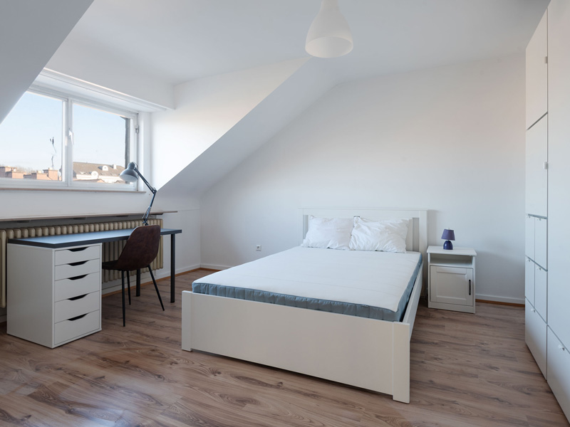 Furnished Room for Rent Luxembourg. It includes: double bed, bedside table, desk, chair, wardrobe, shelf.