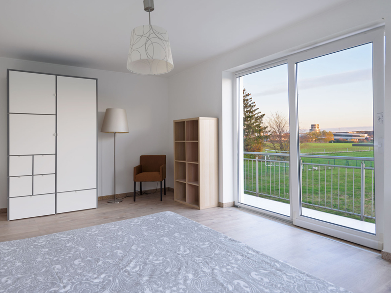 Furnished Room Luxembourg City. The room includes a double bed, bedside table, desk, chair, wardrobe, mirror and a shelf.