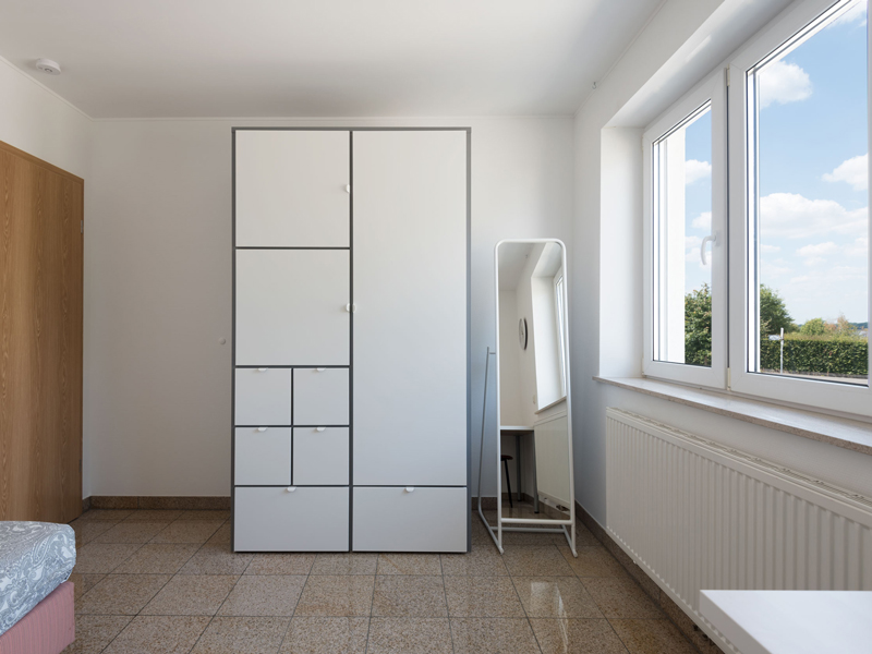 Furnished Room for Rent in Luxembourg. The room includes a single bed, bedside table, desk, chair, wardrobe, mirror.