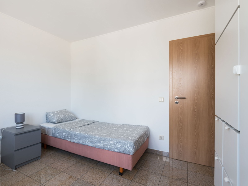 Furnished Room for Rent in Luxembourg. The room includes a single bed, bedside table, desk, chair, wardrobe, mirror.