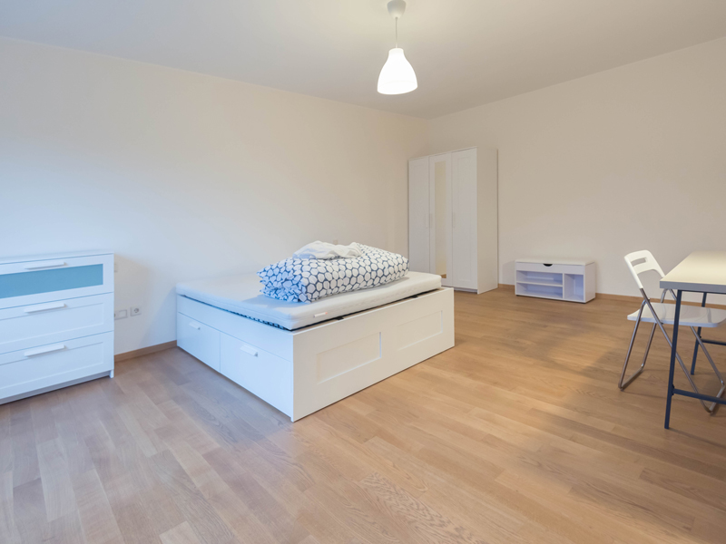 Big furnished room for rent in Luxembourg. The room includes double bed, chest of drawers, wardrobe, desk and a chair.